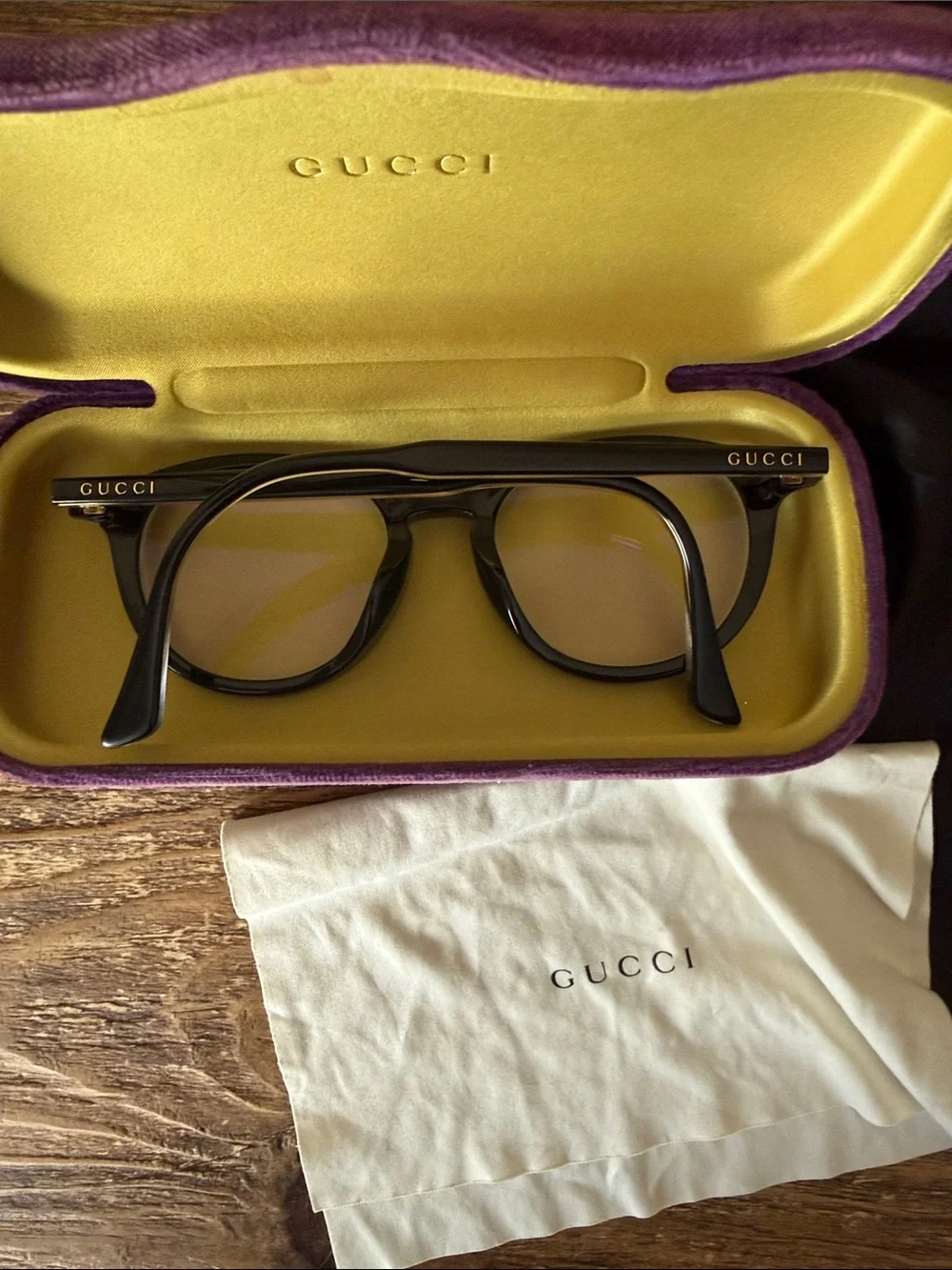 Gucci Black Round Optical Glasses with purple case, dust bag, and cleaning cloth